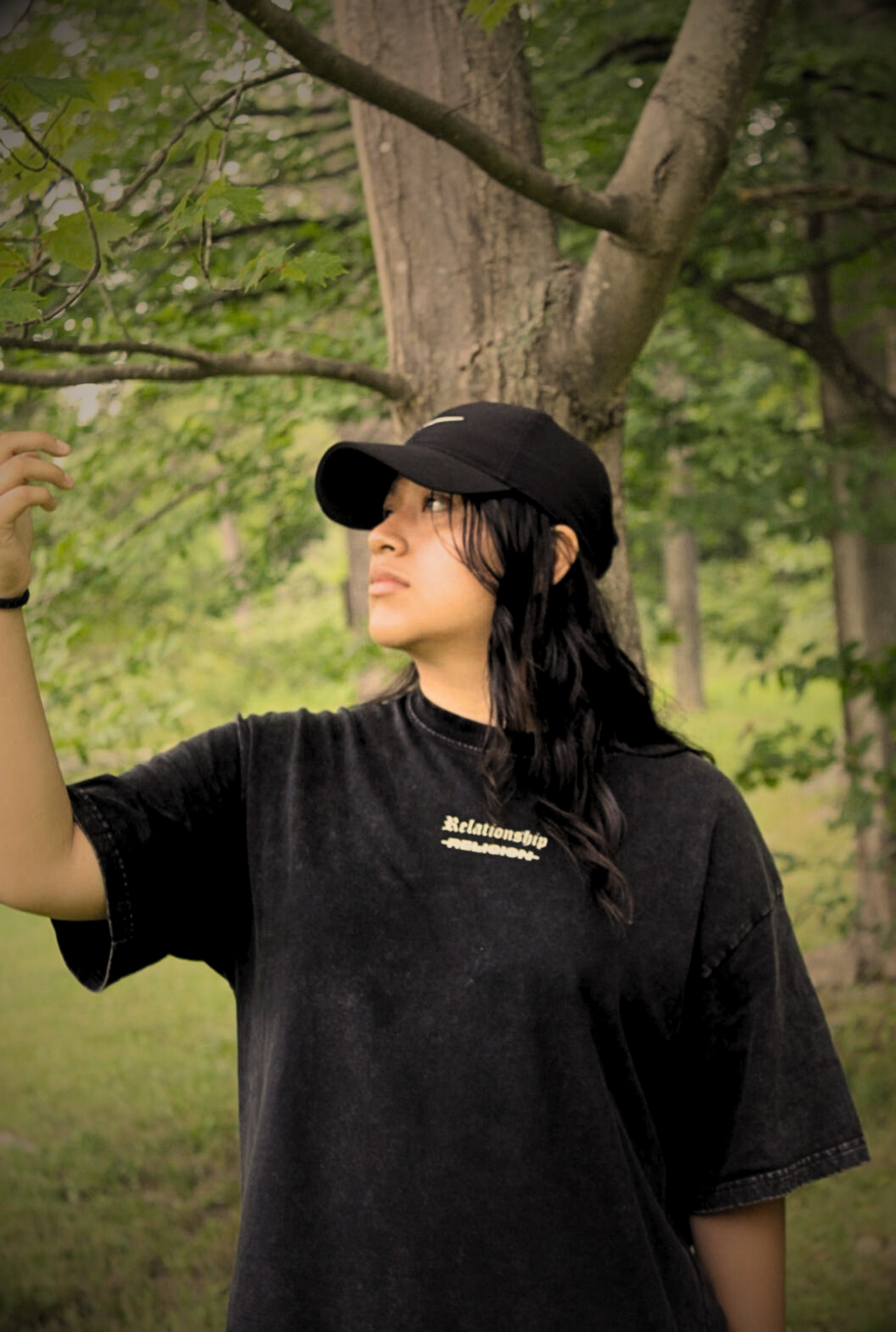 Front shot of female model looking up wearing ABOVE RELIGION Oversized Christian Tee — relationship over religion