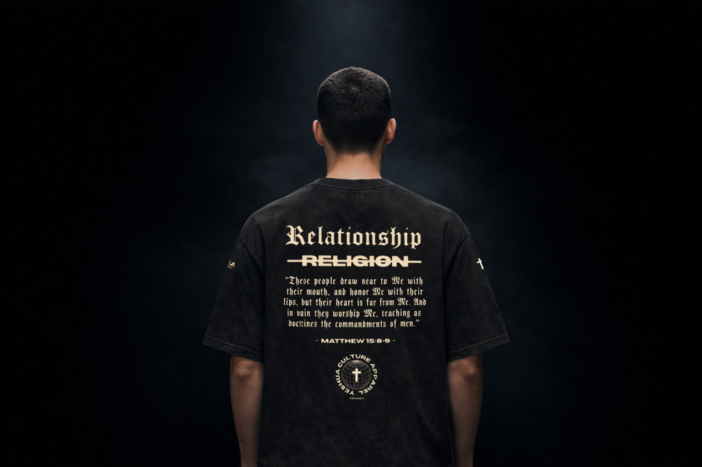 Man wearing ABOVE RELIGION tee, back "Relationship over Religion" graphic, studio shot
