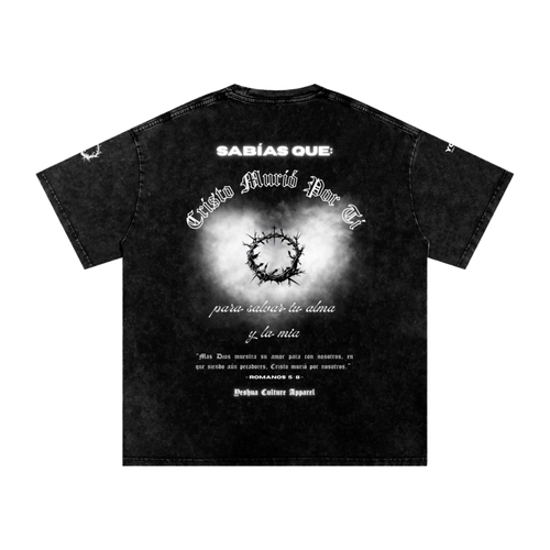 Back of BUENAS NUEVAS tee featuring Romans 5:8 design and verse