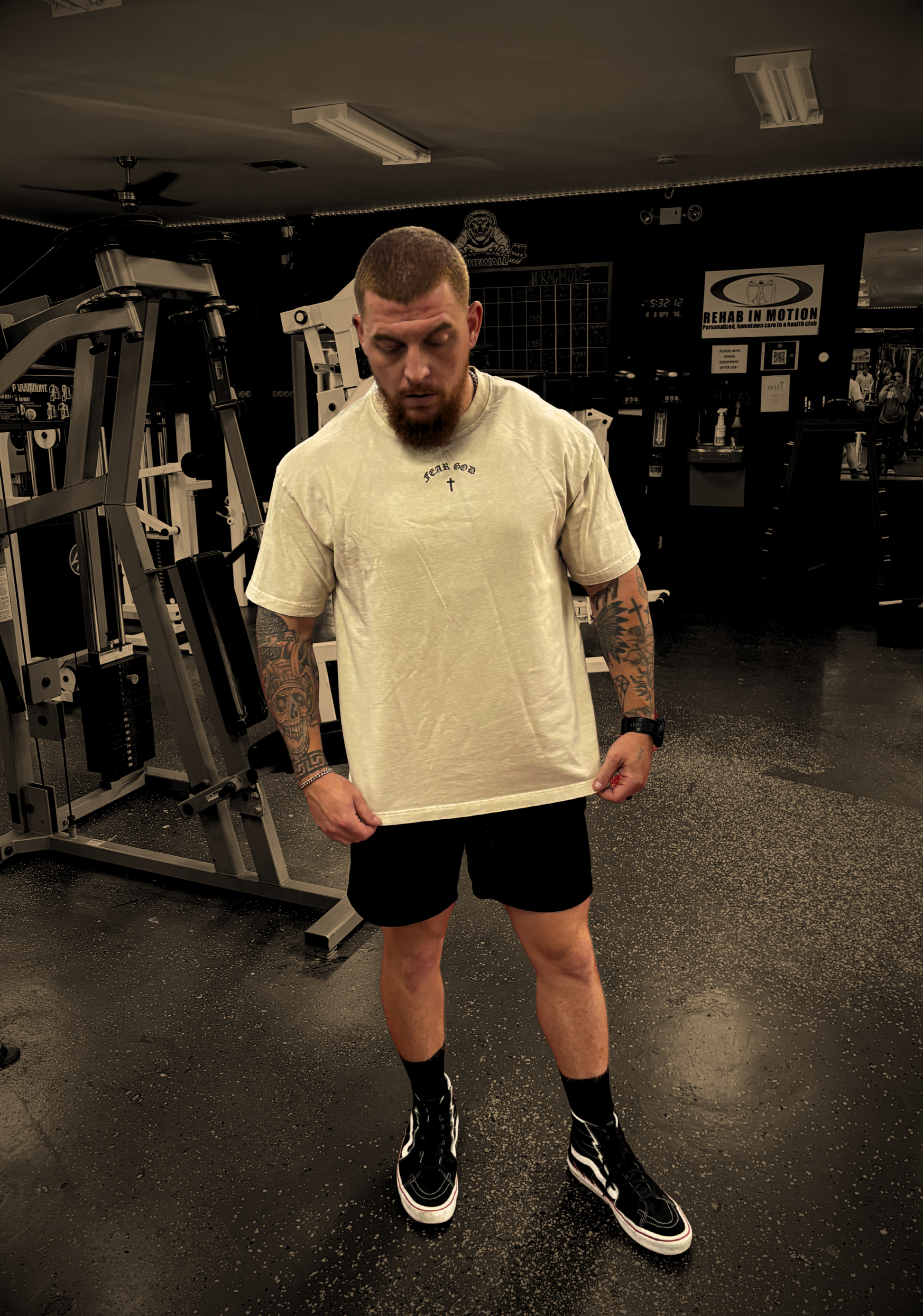 Front shot of model in gym wearing FEAR GOD Oversized Christian Tee — bold Christian streetwear