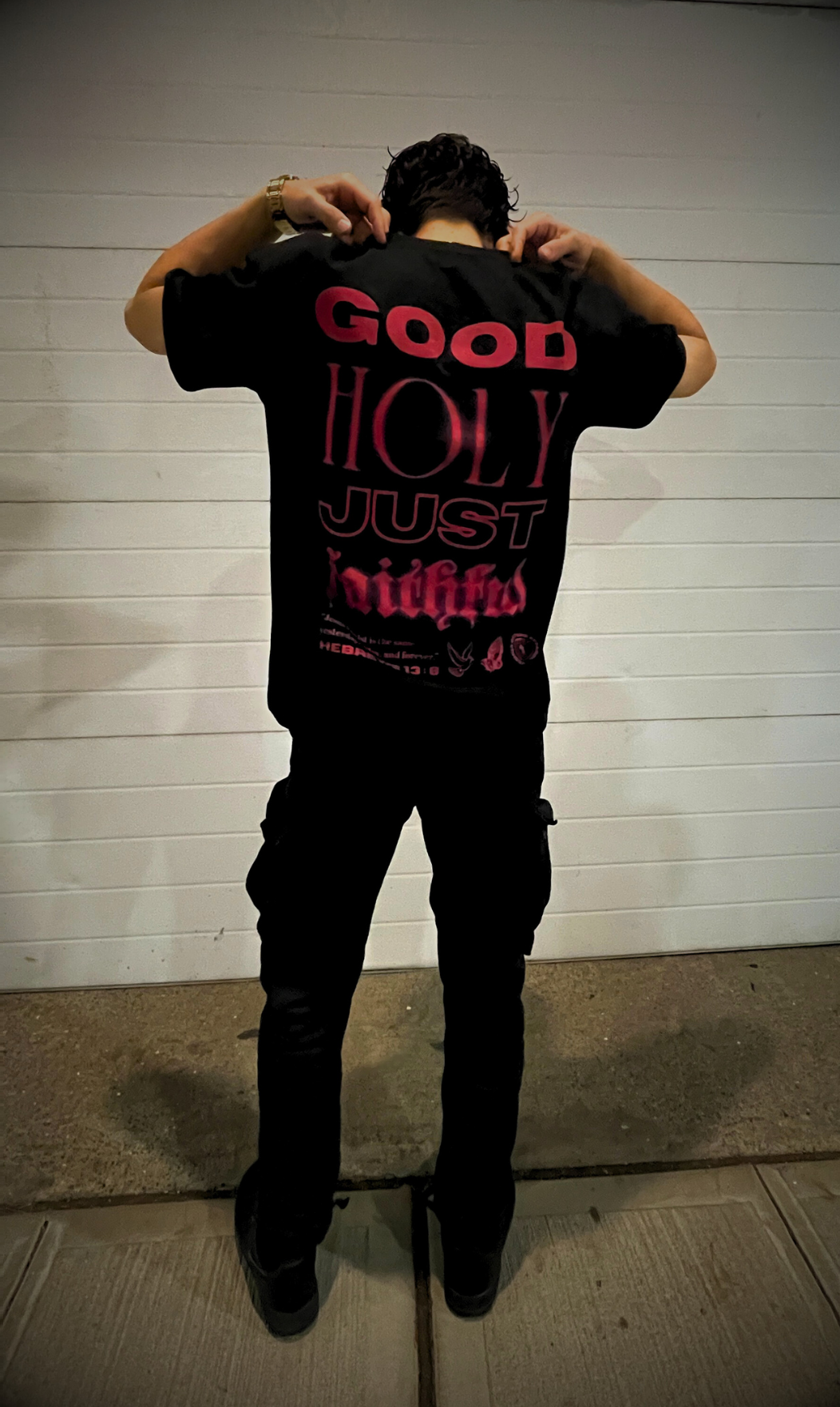 back shot of male model wearing the GOD IS Oversized tee in Jet Black