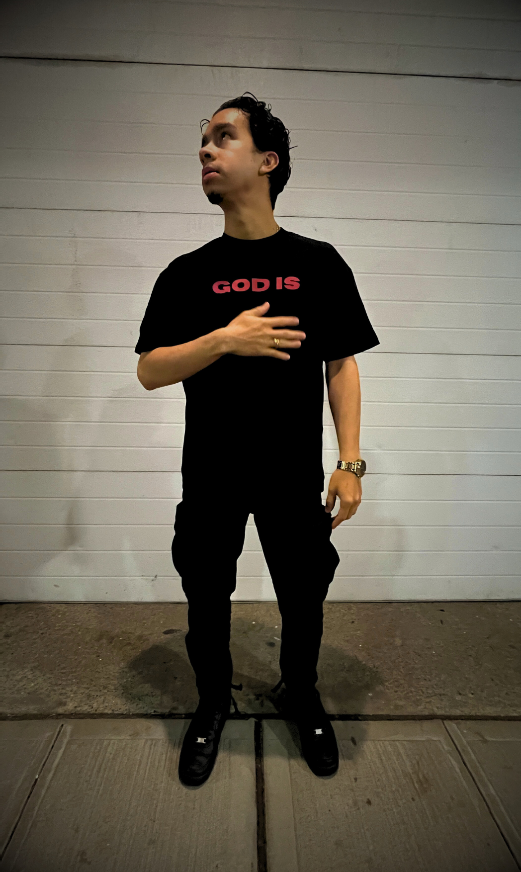 Front shot of male model wearing the GOD IS Oversized tee in Jet Black.