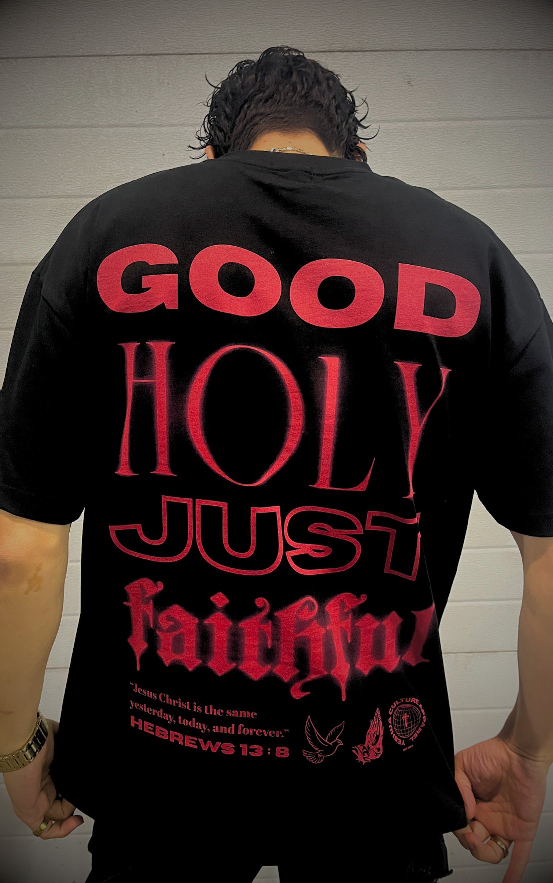 Close up shot of male model wearing the GOD IS Luxe Oversized Tee in Jet Black