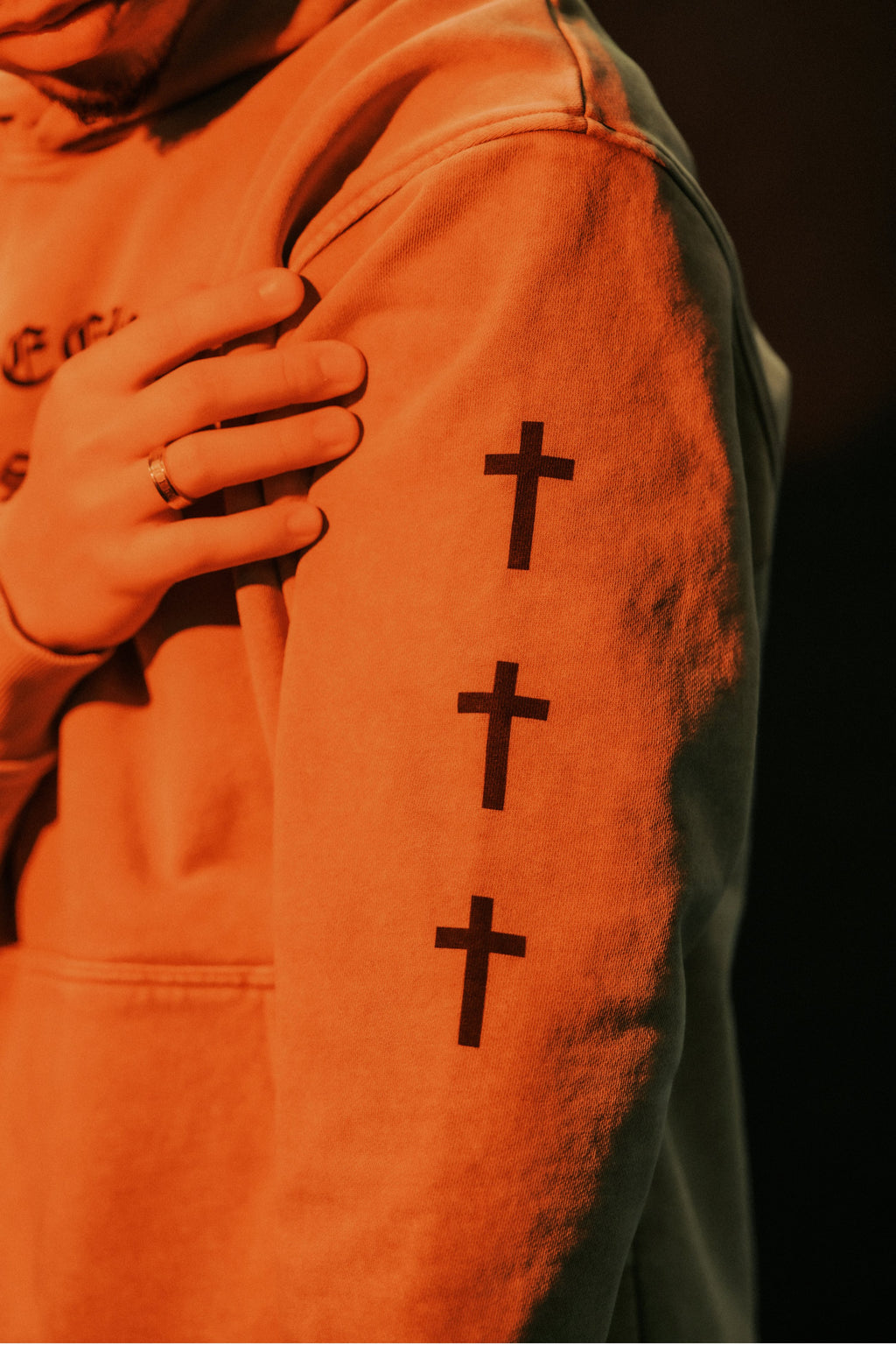 Close-up of triple cross sleeve print on SEEK WISDOM Christian hoodie