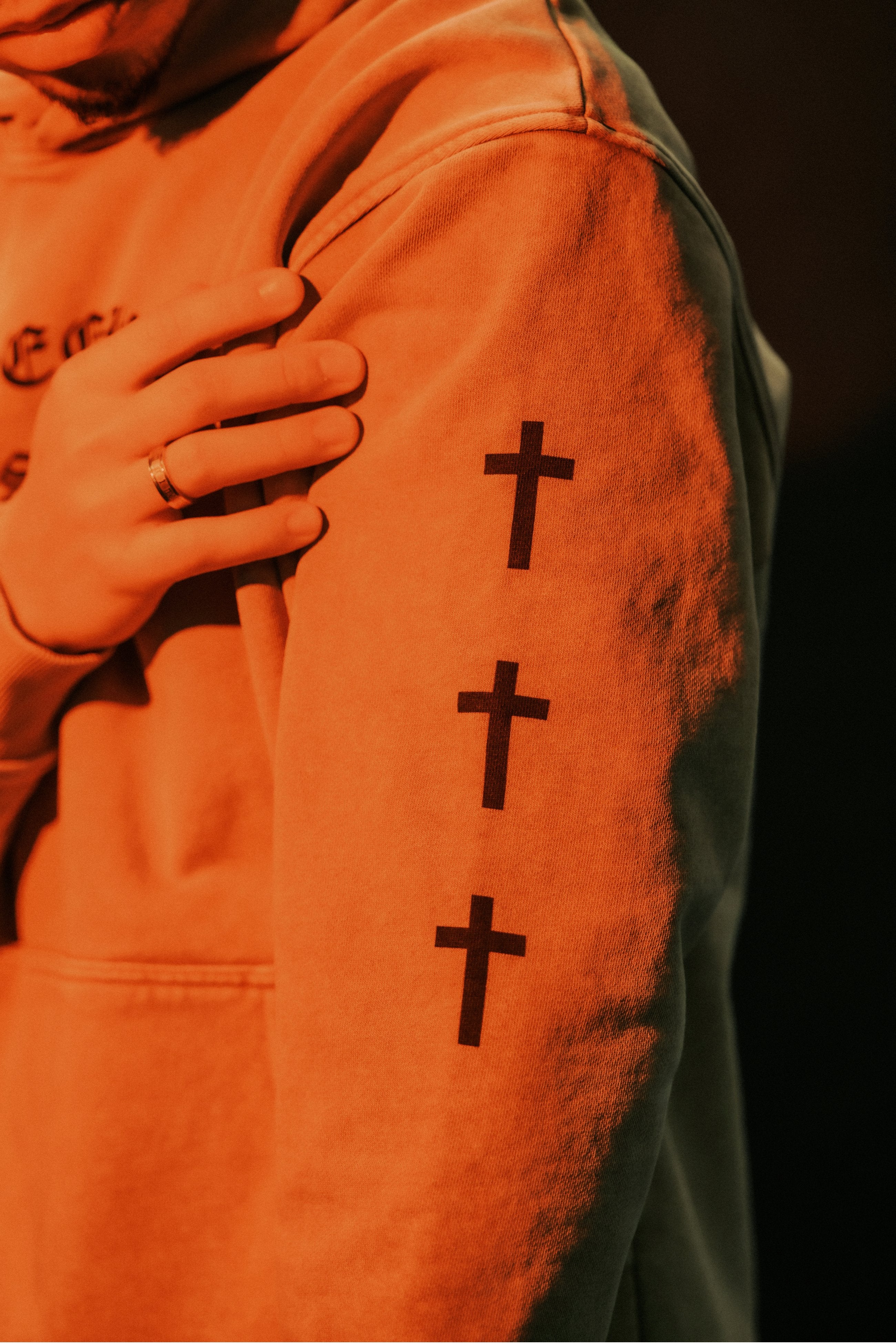 Close-up of triple cross sleeve print on SEEK WISDOM Christian hoodie